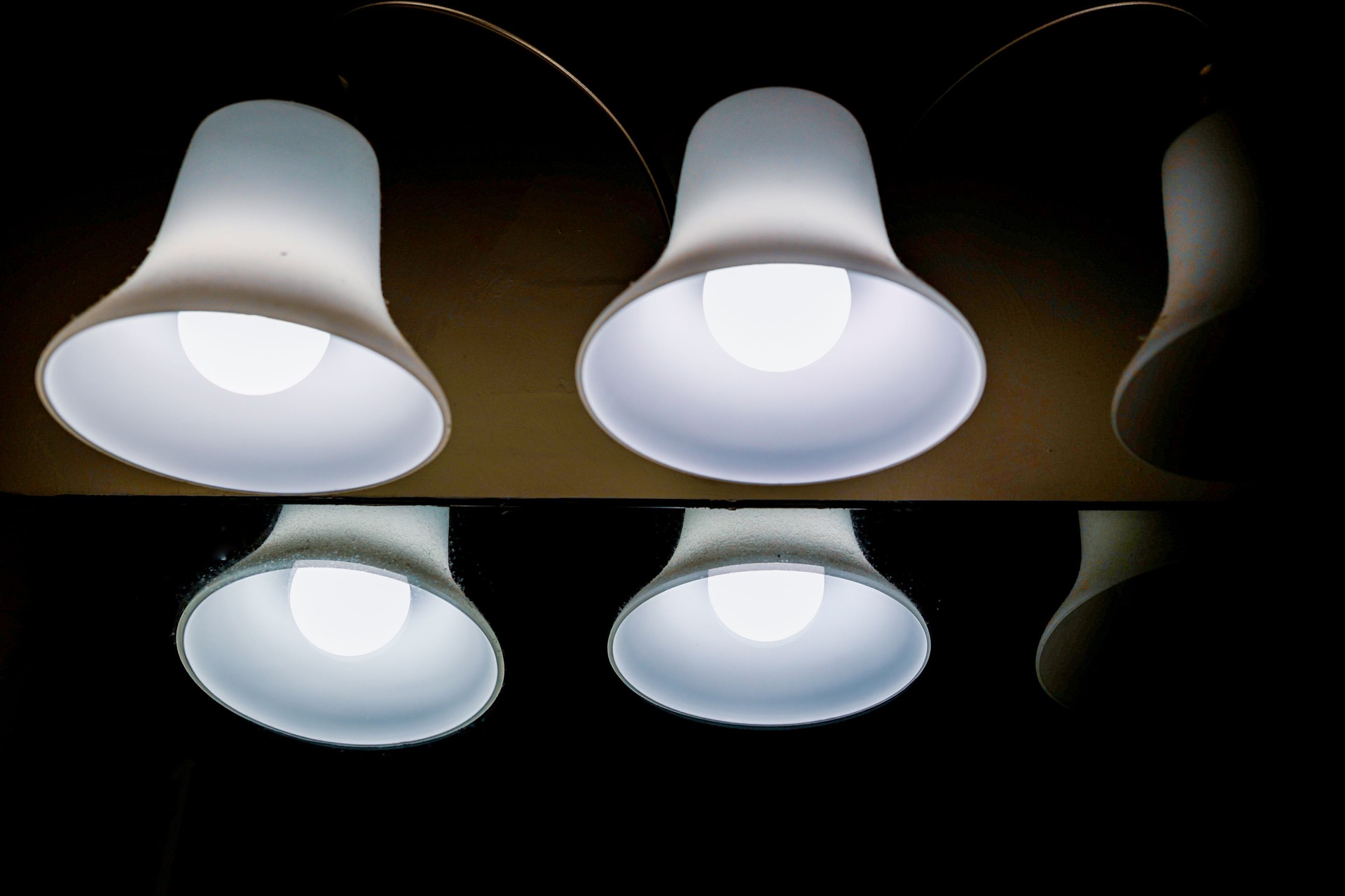 A missing lightbulb in a bathroom lamp